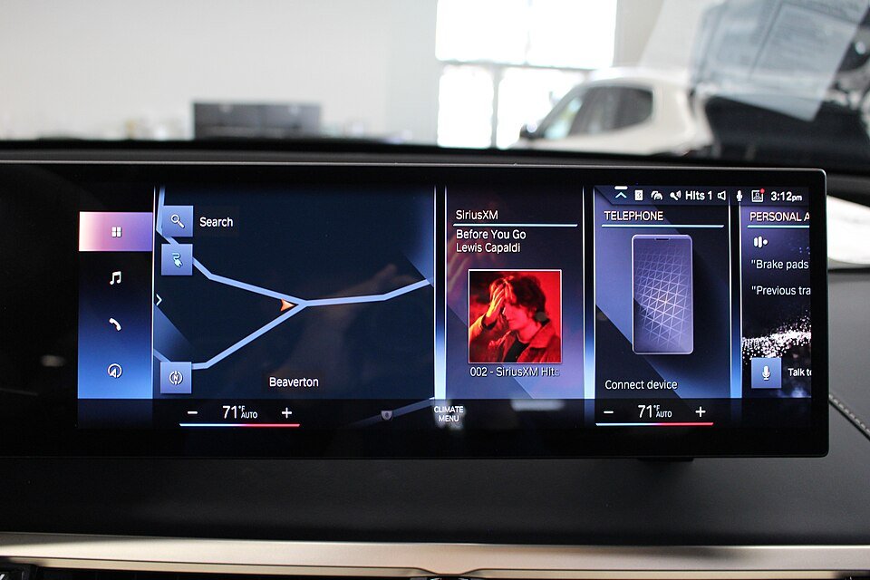 BMW iX M60 central iDrive 8 screen showing navigation and media tiles