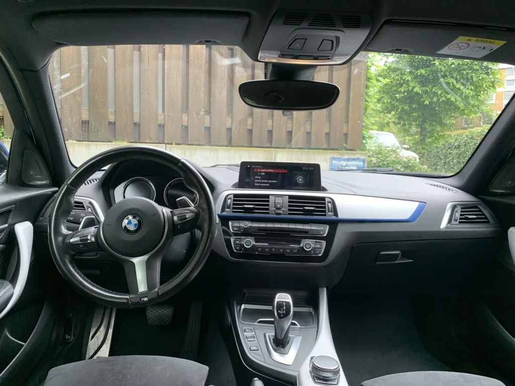 BMW F20 dashboard with iDrive screen and climate controls