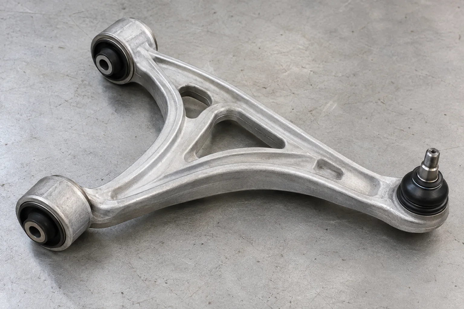 Illustration of a lower control arm with bushes and a ball joint