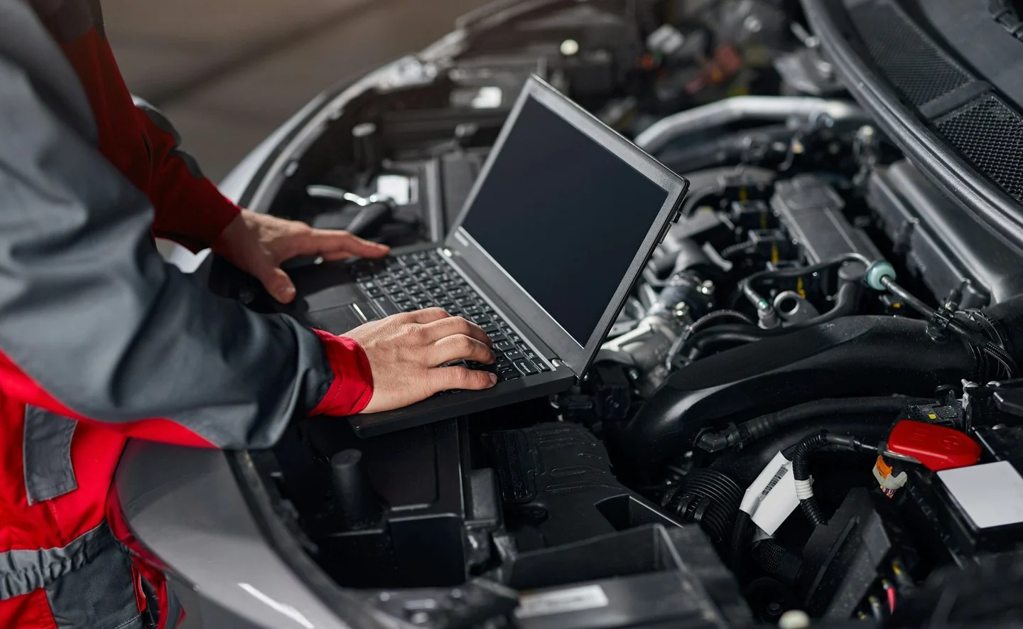 Illustration of diagnostic equipment beside a BMW engine bay