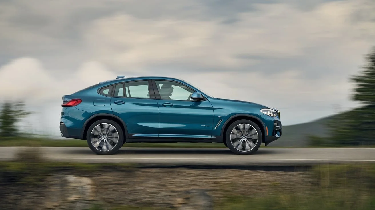 Blue BMW X4 in side profile